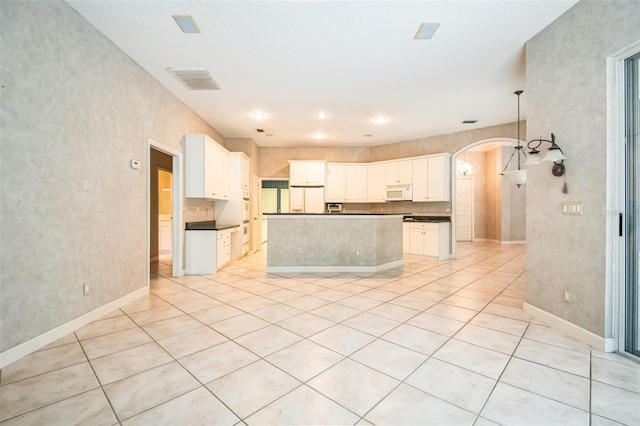 kitchen featuring white cabinetry, white appliances, and a center island