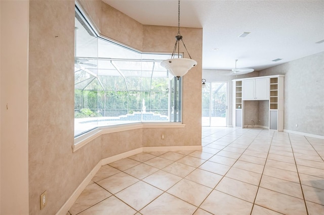 unfurnished dining area with light tile patterned flooring