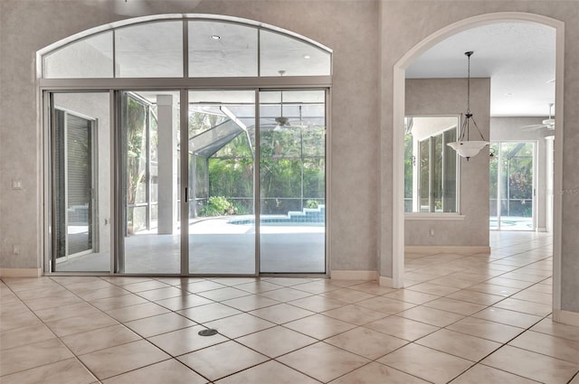 entryway with light tile patterned floors and ceiling fan