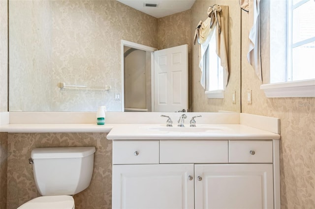 bathroom with vanity, plenty of natural light, and toilet