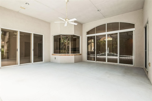 exterior space featuring ceiling fan