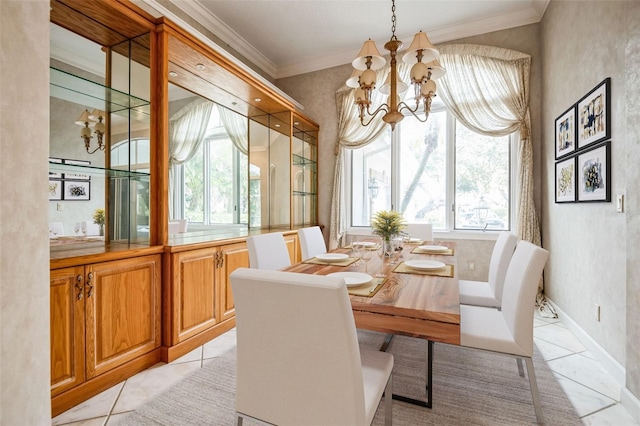 dining room with an inviting chandelier, crown molding, and light tile patterned flooring