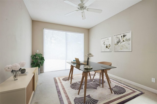 office area with ceiling fan, light colored carpet, and a textured ceiling