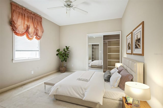 carpeted bedroom featuring ceiling fan and a closet