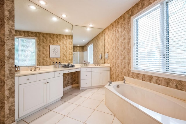 bathroom with tile patterned flooring, vanity, and shower with separate bathtub