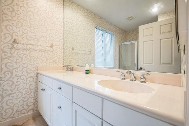 bathroom featuring vanity, a shower with door, and tile patterned flooring