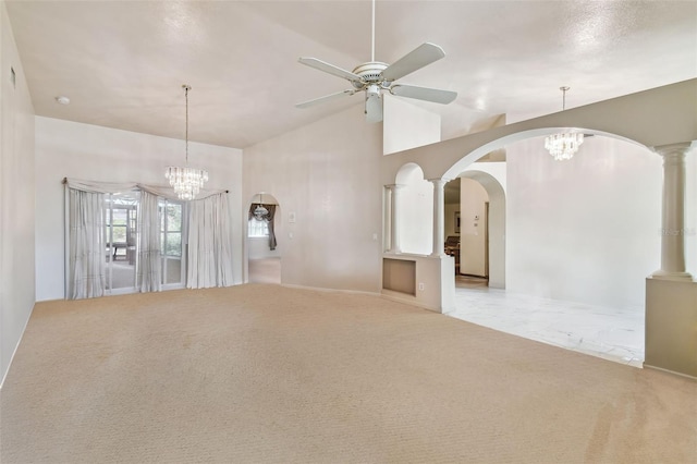 unfurnished living room featuring high vaulted ceiling, ceiling fan with notable chandelier, light colored carpet, and ornate columns