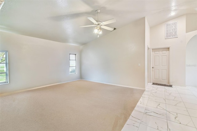 spare room featuring high vaulted ceiling and ceiling fan