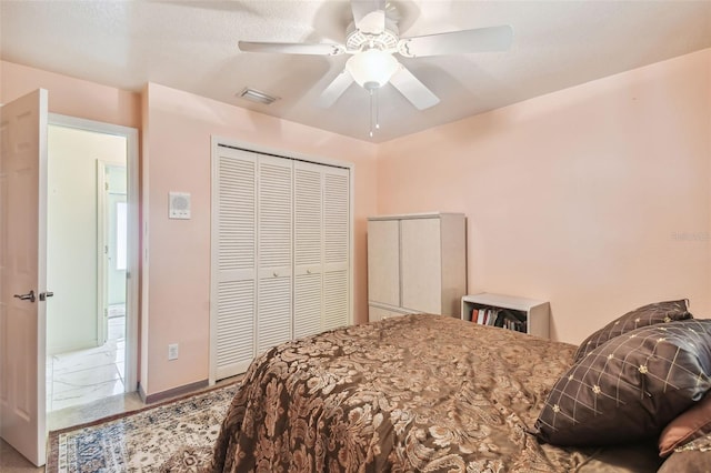 bedroom with ceiling fan and a closet