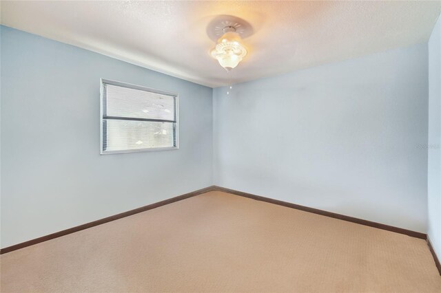 carpeted empty room with a textured ceiling