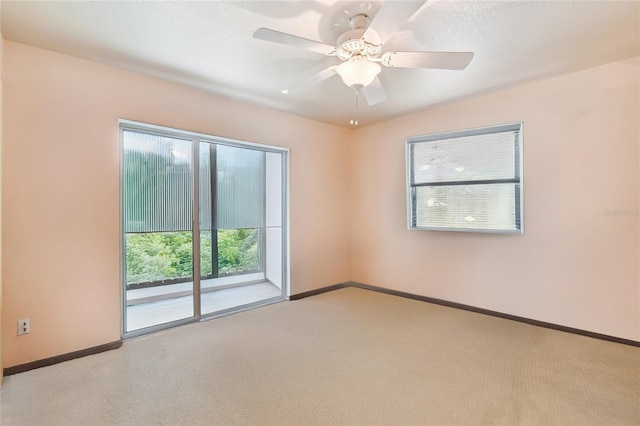 carpeted empty room with ceiling fan