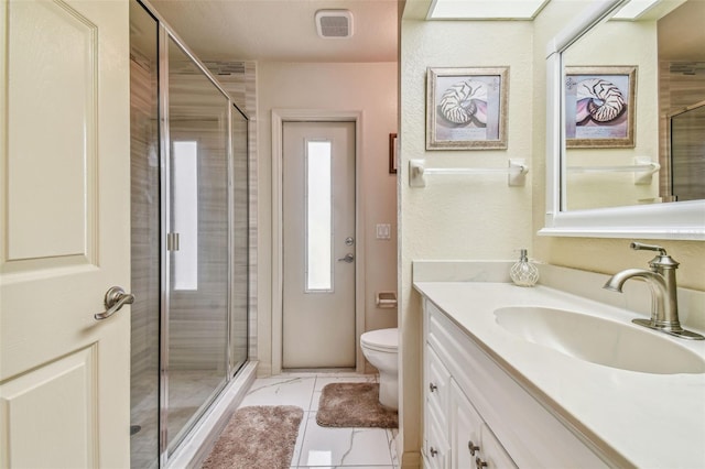 bathroom with vanity, toilet, and walk in shower