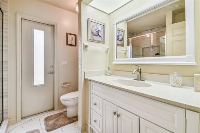 bathroom featuring vanity, toilet, and a shower with door