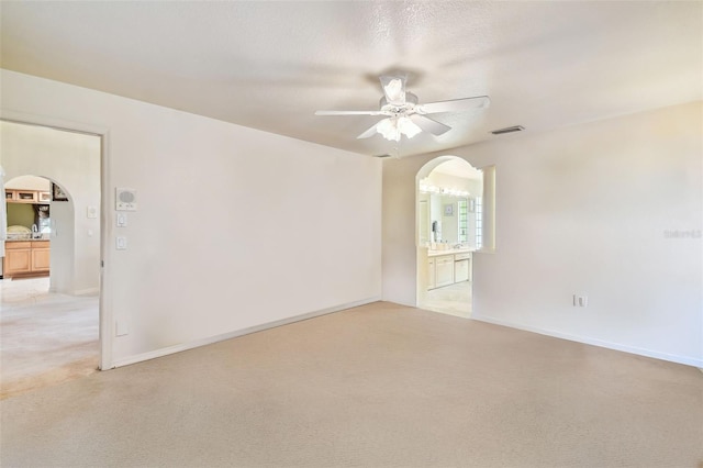 carpeted empty room with a textured ceiling and ceiling fan