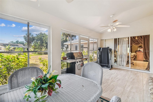 sunroom featuring vaulted ceiling and ceiling fan