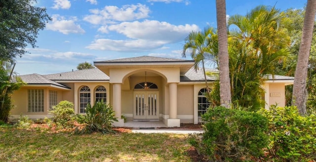 exterior space featuring a lawn and french doors