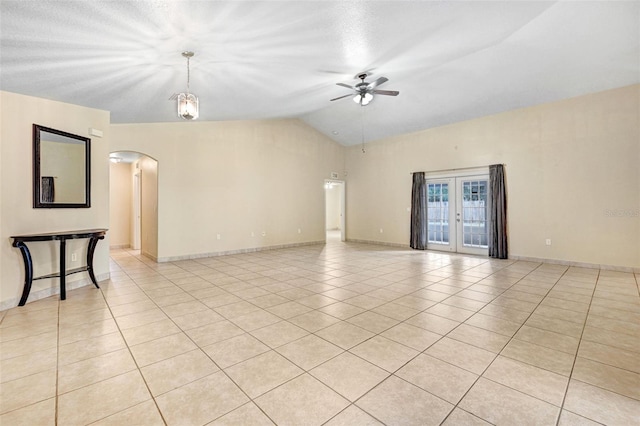 unfurnished room featuring light tile patterned flooring, vaulted ceiling, ceiling fan, and french doors