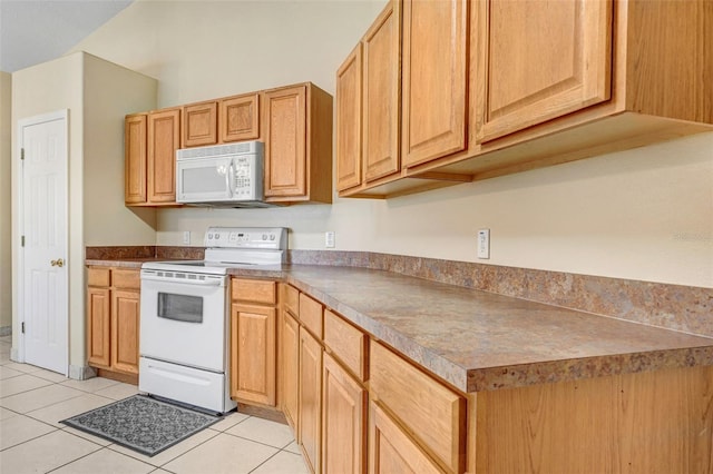 kitchen with white appliances and light tile patterned floors