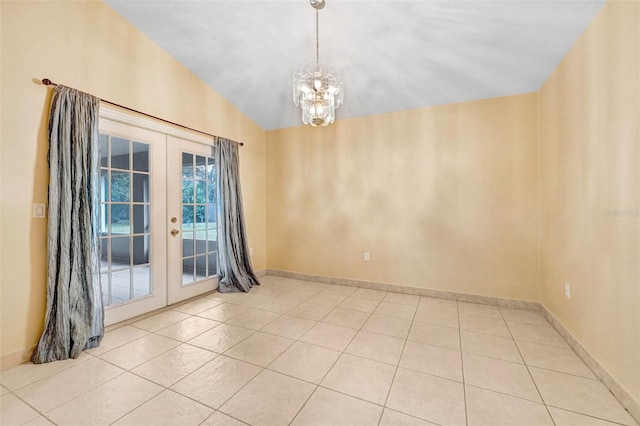 tiled empty room featuring vaulted ceiling, a notable chandelier, and french doors