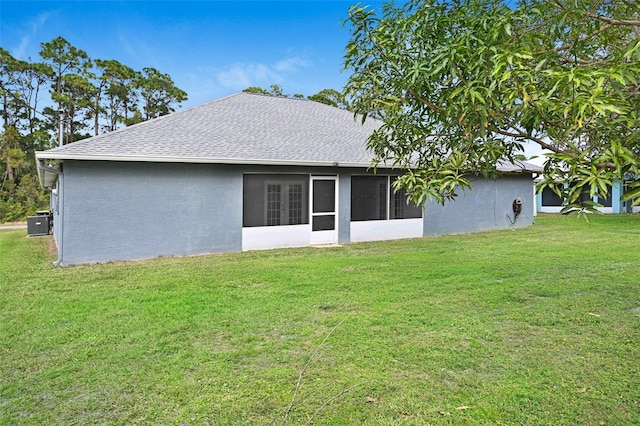 rear view of property with a lawn