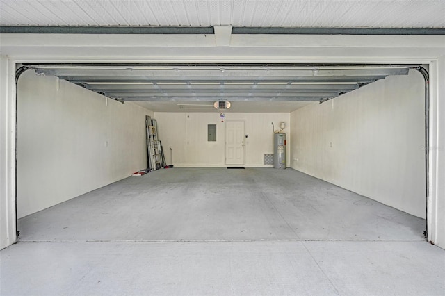 garage with water heater, a garage door opener, and electric panel