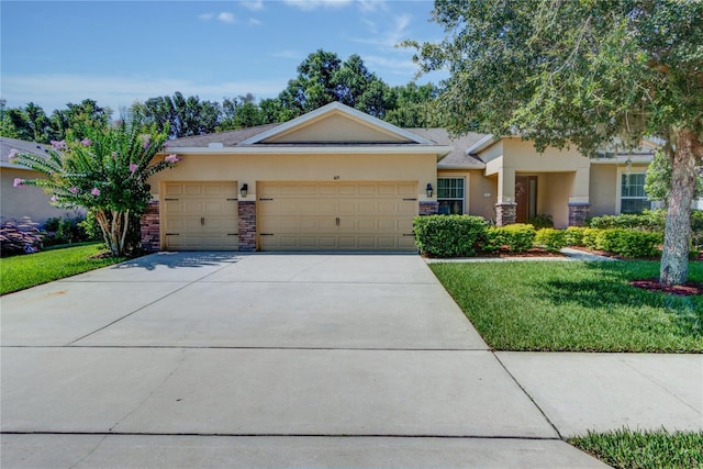 view of front of home with a garage and a front lawn