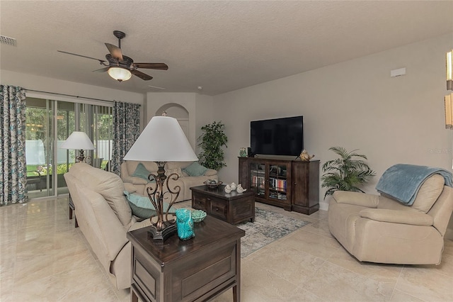 619 Meadow Sage Dr, Deland, FL 32724 - living room with ceiling fan and a textured ceiling