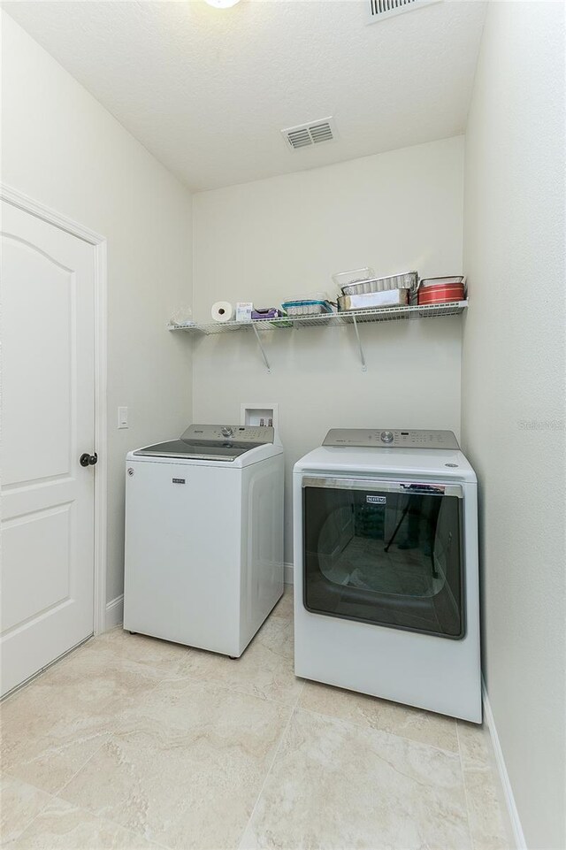 619 Meadow Sage Dr, Deland, FL 32724 - clothes washing area with washing machine and clothes dryer