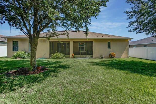 619 Meadow Sage Dr, Deland, FL 32724 - rear view of house featuring a yard and a sunroom