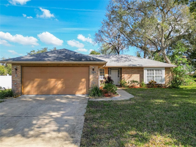 single story home featuring a garage and a front yard