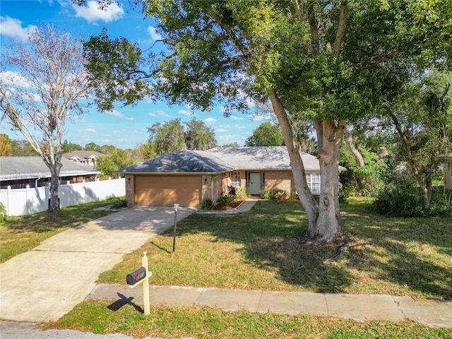 ranch-style house with a garage and a front lawn