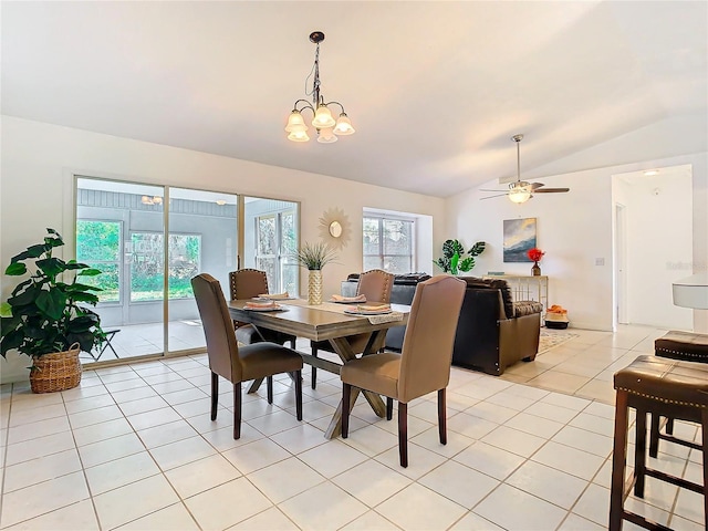 tiled dining area featuring lofted ceiling and ceiling fan with notable chandelier