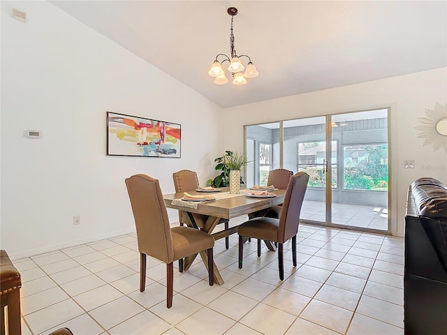 dining room featuring plenty of natural light, vaulted ceiling, and light tile patterned flooring