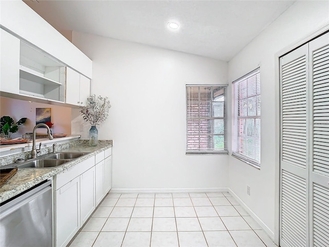 kitchen featuring light stone counters, white cabinets, sink, and dishwasher