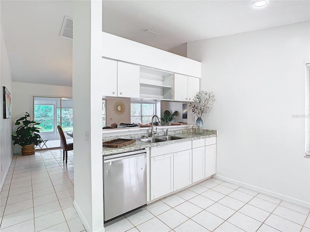 kitchen with white cabinetry, sink, stainless steel dishwasher, and light tile patterned floors