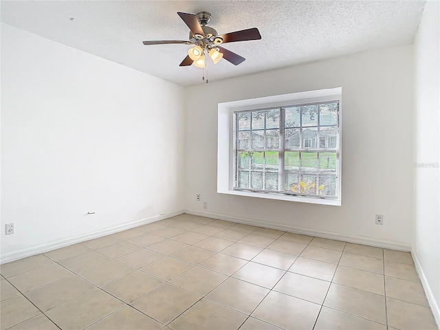 empty room featuring ceiling fan and a textured ceiling