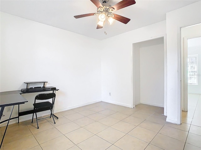 home office with light tile patterned floors and ceiling fan