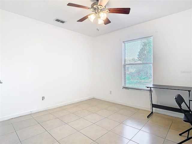 spare room featuring light tile patterned flooring and ceiling fan