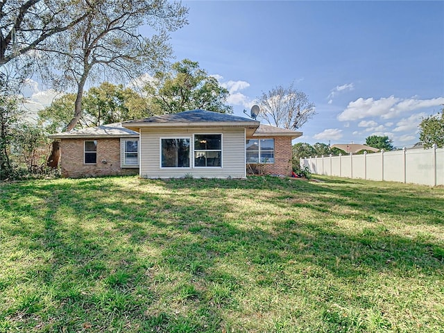 back of house with a lawn