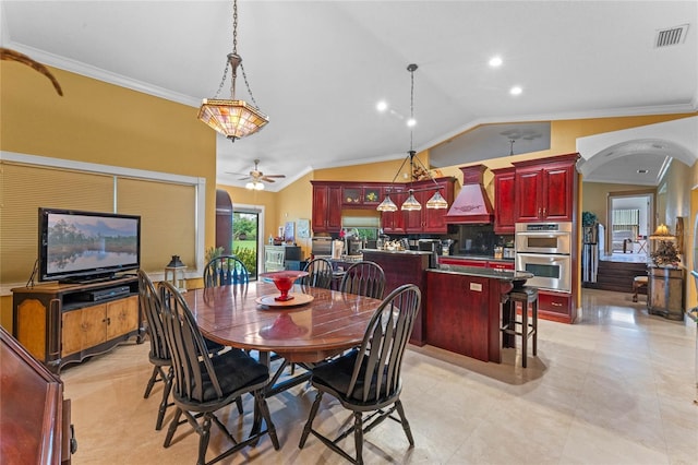 dining room with ornamental molding, lofted ceiling, and a wealth of natural light