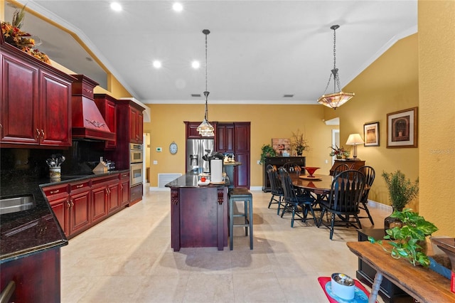 kitchen with pendant lighting, stainless steel appliances, a breakfast bar, and a kitchen island