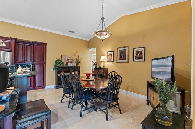 dining space with crown molding and lofted ceiling