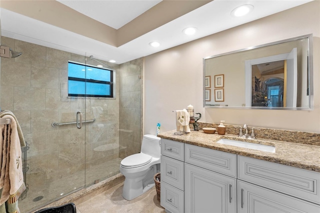 bathroom featuring walk in shower, vanity, and toilet