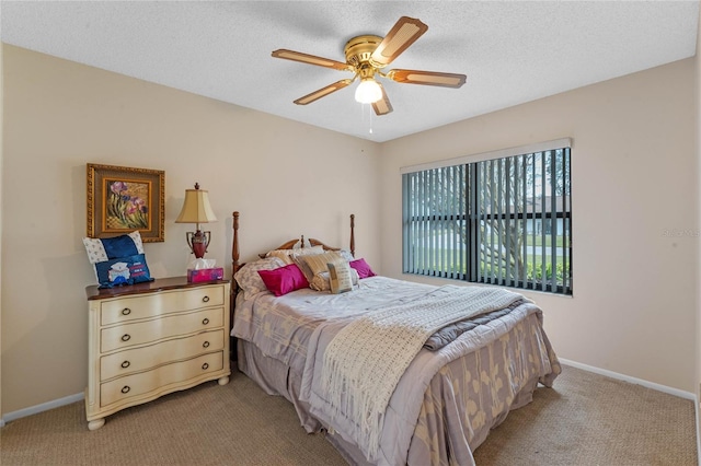 bedroom featuring ceiling fan, light carpet, and a textured ceiling