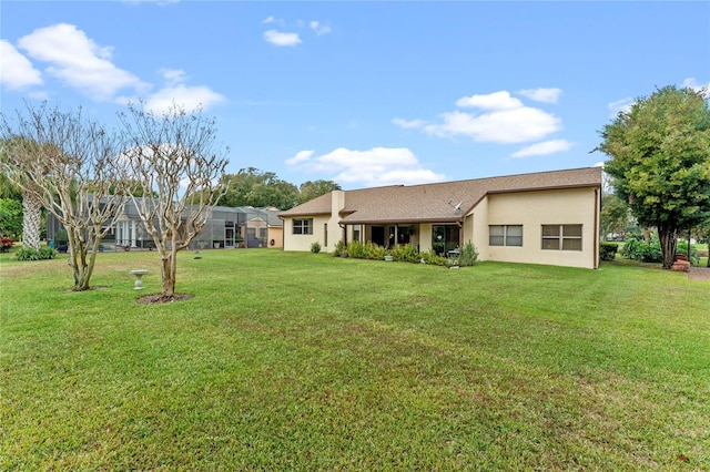 back of property featuring a lawn