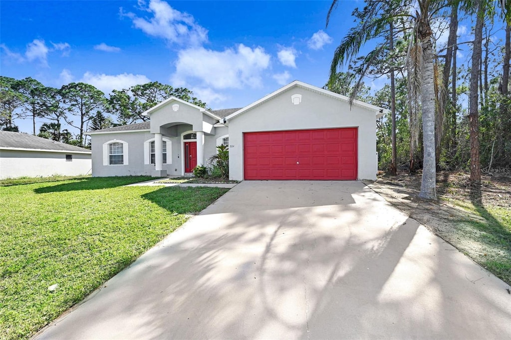884 Hainey St SW, Palm Bay, FL 32908 - view of front of home featuring a garage and a front lawn