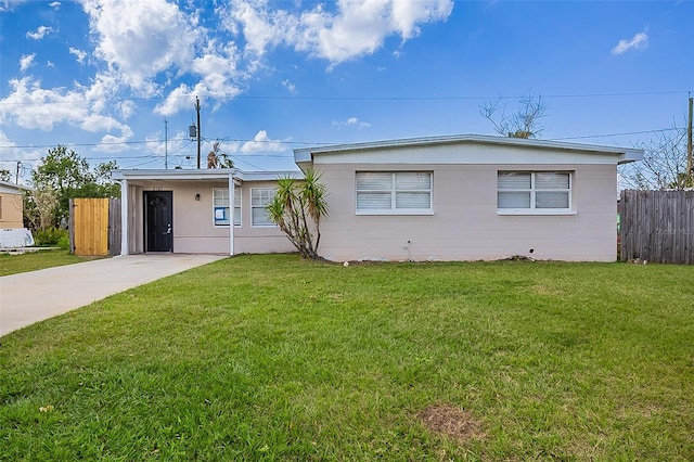 view of front of house featuring driveway, a front lawn, and fence