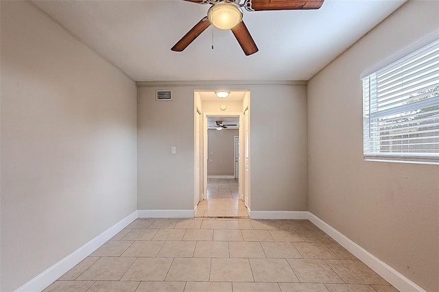 unfurnished room featuring visible vents, ceiling fan, baseboards, and light tile patterned floors