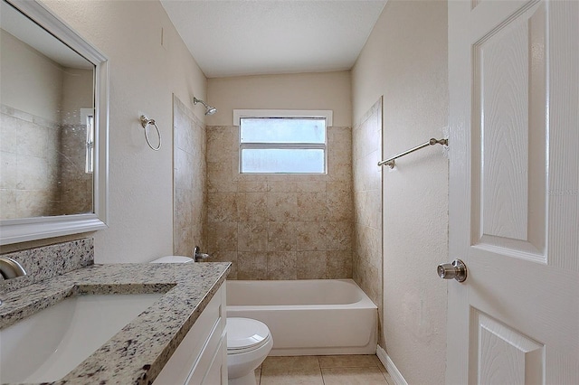 bathroom with a textured wall, toilet, washtub / shower combination, vanity, and tile patterned flooring