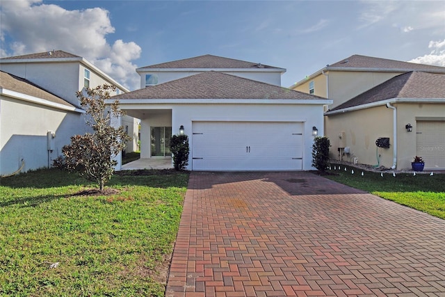 view of front of home with a front lawn and a garage